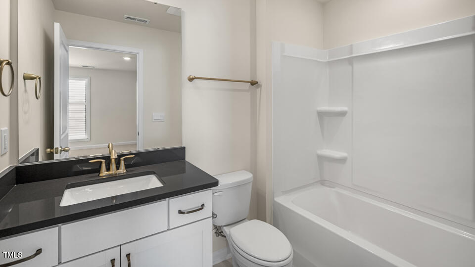 154 Red Jasper Way Clayton, NC 27520 - Photo 19 of 33 a bathroom with a sink a toilet and a bathtub