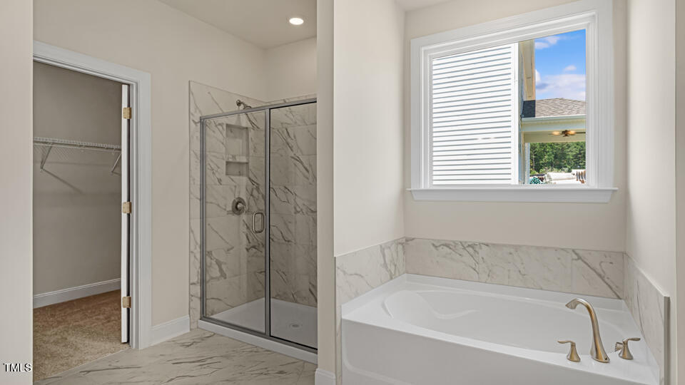 154 Red Jasper Way Clayton, NC 27520 - Photo 28 of 33 a white bath tub sitting next to a shower