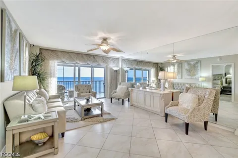 a living room with furniture and a lamp