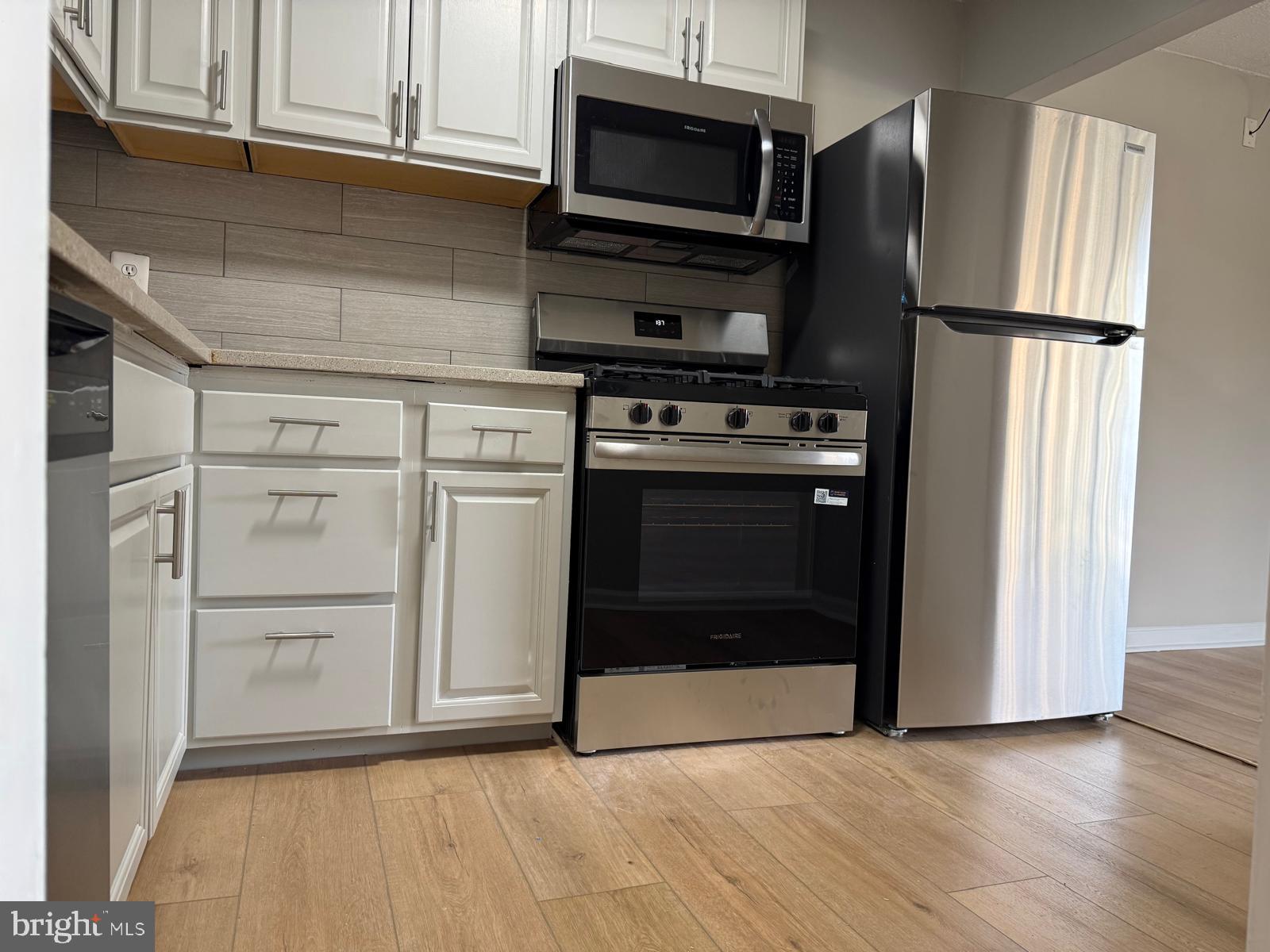 2630 Fort Farnsworth Road, Unit 148 Alexandria, VA 22303 - Photo 2 of 12 a kitchen with white cabinets and stainless steel appliances