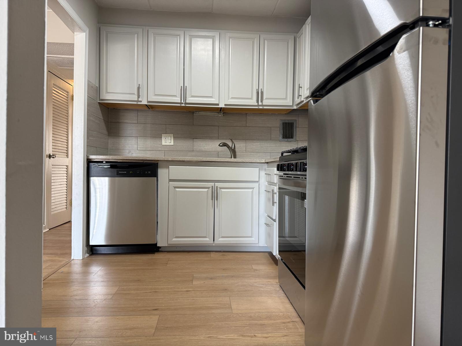 2630 Fort Farnsworth Road, Unit 148 Alexandria, VA 22303 - Photo 3 of 12 a kitchen with stainless steel appliances granite countertop a stove a refrigerator and a sink