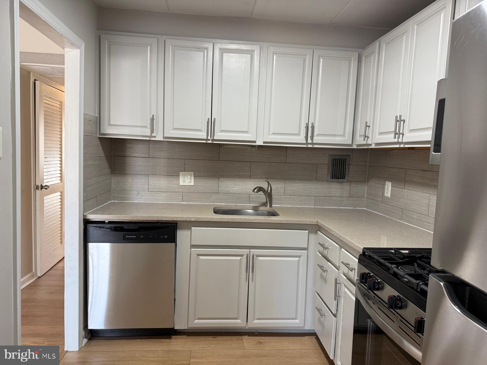 2630 Fort Farnsworth Road, Unit 148 Alexandria, VA 22303 - Photo 4 of 12 a kitchen with granite countertop white cabinets and stainless steel appliances