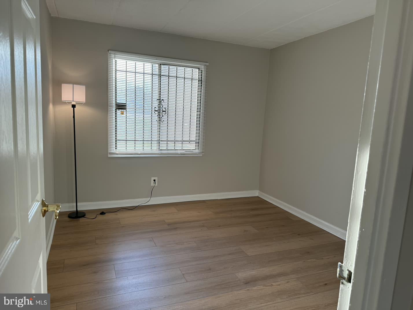 2630 Fort Farnsworth Road, Unit 148 Alexandria, VA 22303 - Photo 7 of 12 an empty room with wooden floor and windows