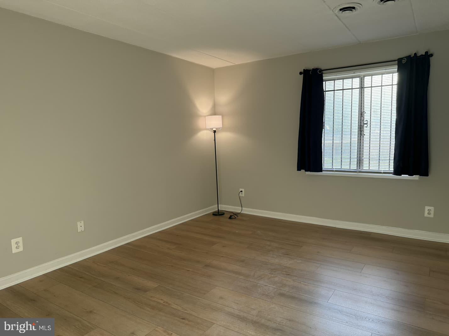 2630 Fort Farnsworth Road, Unit 148 Alexandria, VA 22303 - Photo 9 of 12 an empty room with wooden floor and windows