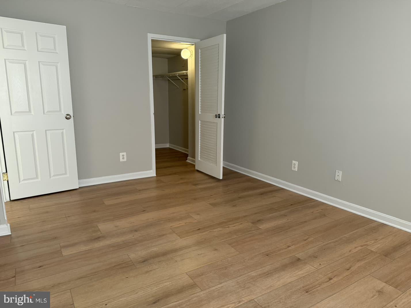 2630 Fort Farnsworth Road, Unit 148 Alexandria, VA 22303 - Photo 10 of 12 an empty room with wooden floor and closet area