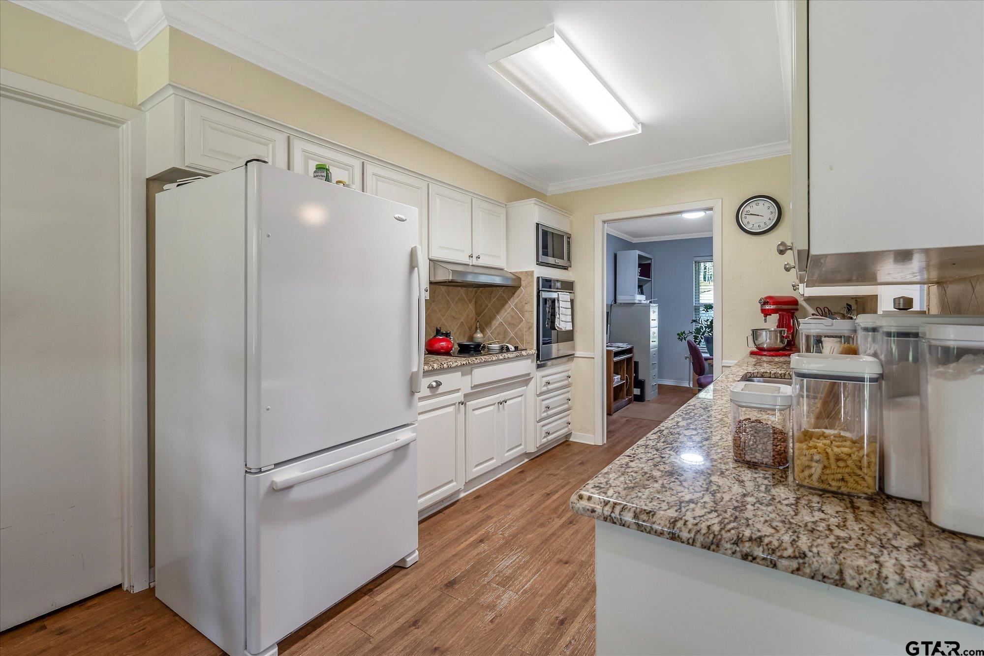 3724 Pollard Drive Tyler, TX 75701 - Photo 11 of 28 a kitchen with white cabinets and white appliances