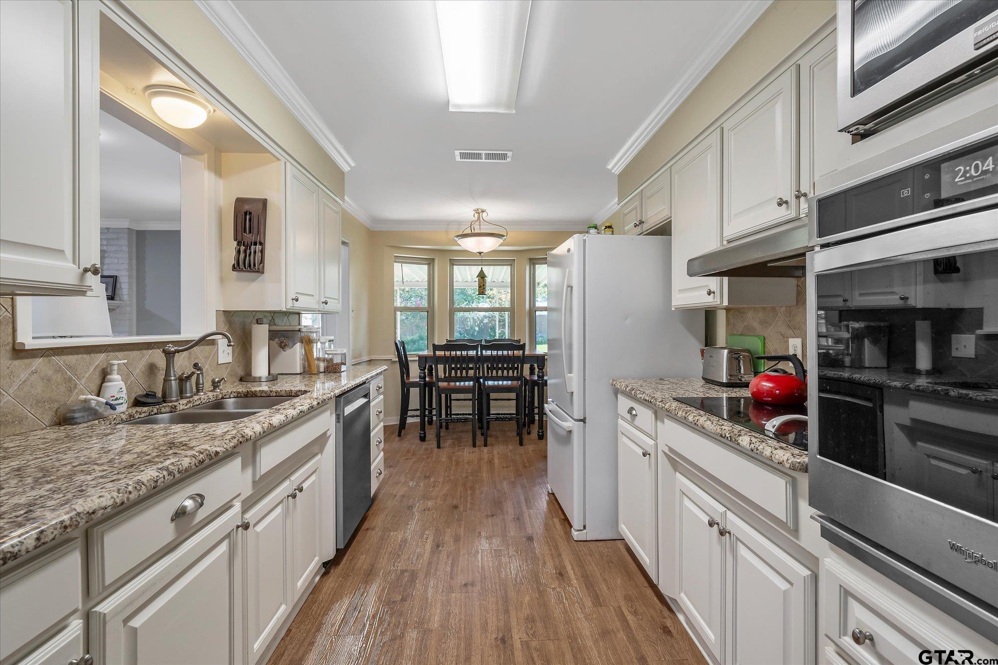 3724 Pollard Drive Tyler, TX 75701 - Photo 12 of 28 a kitchen with lots of counter top space and wooden floor