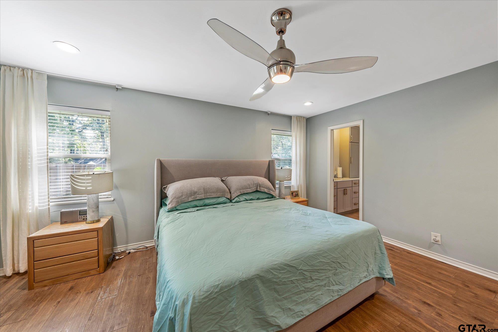 3724 Pollard Drive Tyler, TX 75701 - Photo 16 of 28 a bedroom with a bed and wooden floor