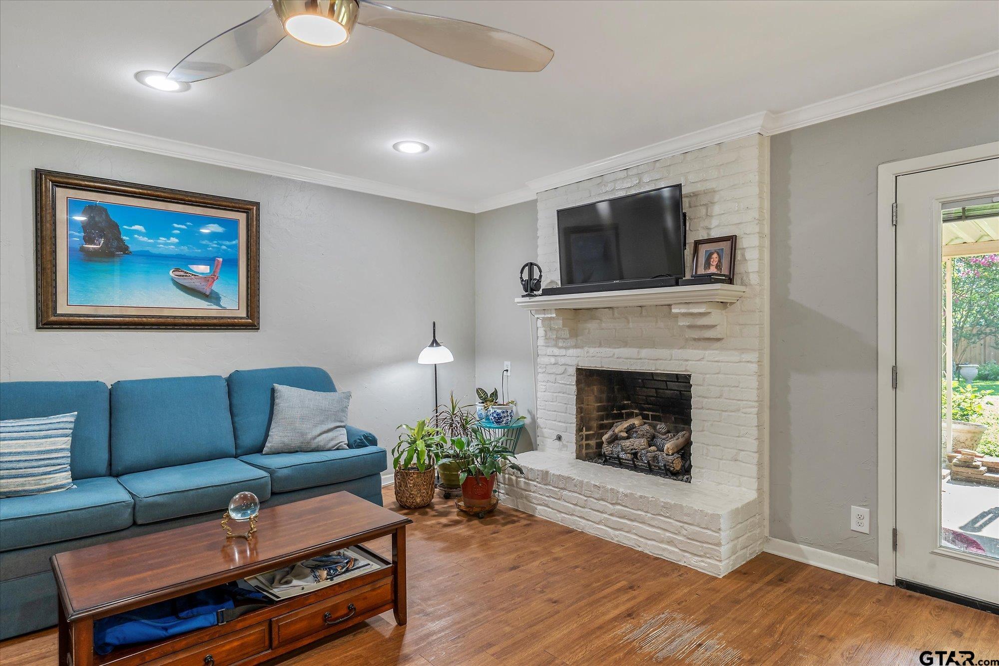 3724 Pollard Drive Tyler, TX 75701 - Photo 25 of 28 a living room with furniture a flat screen tv and a fireplace