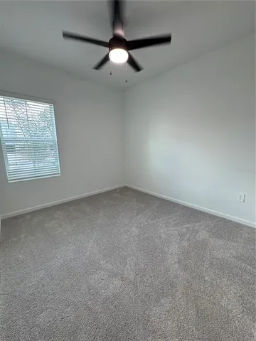 an empty room with a empty space and windows