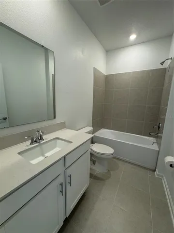 a bathroom with a double vanity sink toilet mirror and shower
