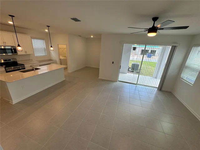 a large kitchen with stainless steel appliances a large counter top
