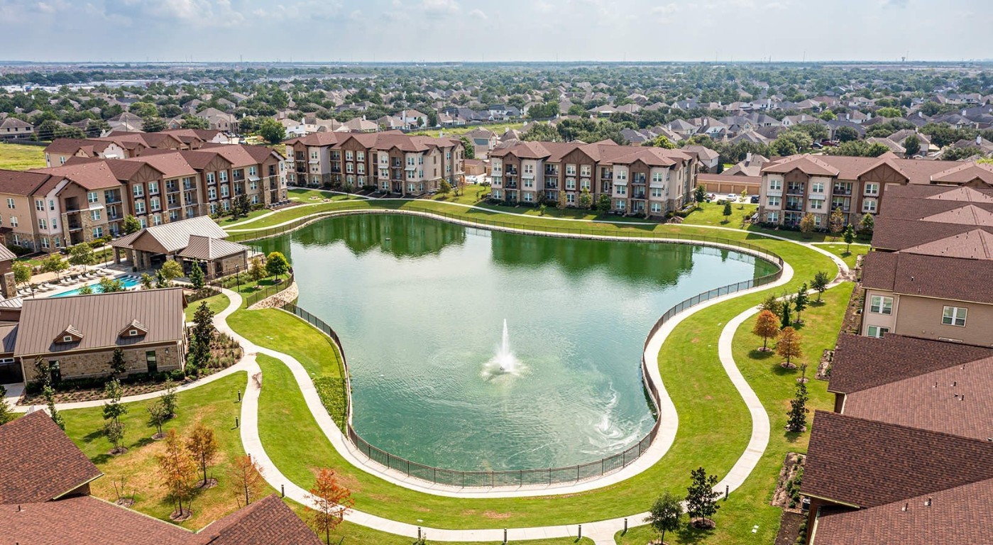 1700 Katy Fort Bend Road, Unit 2311 Katy, TX 77493 - Photo 28 of 30 an aerial view of a swimming pool with outdoor seating and city view