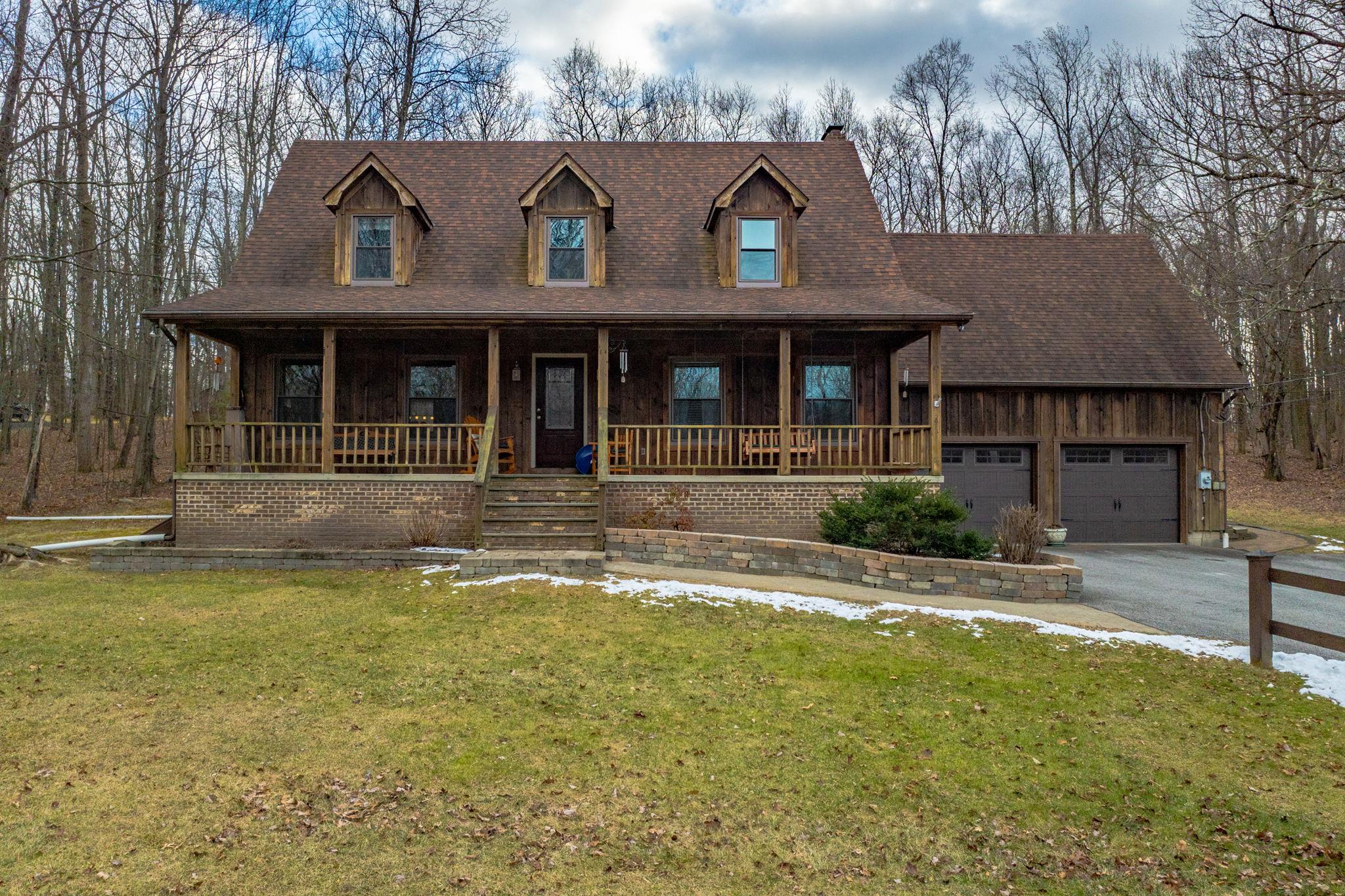 135 Post Road Slate Hill, NY 10973 - Photo 1 of 1 View of front of property featuring a front yard, a garage, and a porch