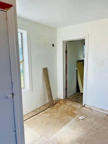 a view of a room with mirror and a window