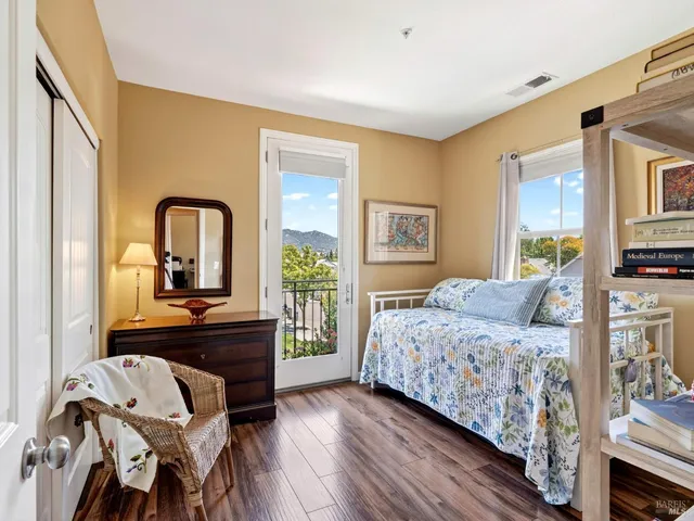 a bedroom with a bed and a dresser with mirror