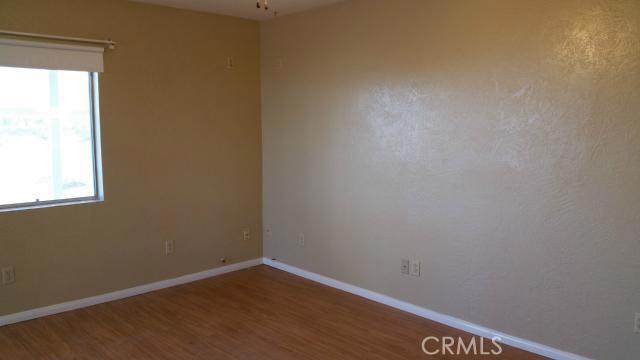 62323 Mars Drive Joshua Tree, CA 92252 - Photo 12 of 26 a view of an empty room with wooden floor and a window
