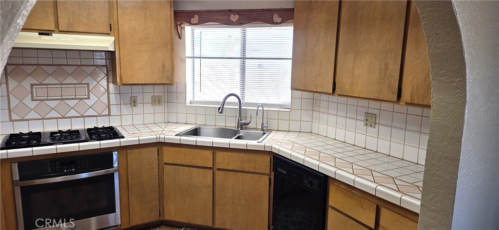 62323 Mars Drive Joshua Tree, CA 92252 - Photo 2 of 26 a kitchen with a sink stove and cabinets