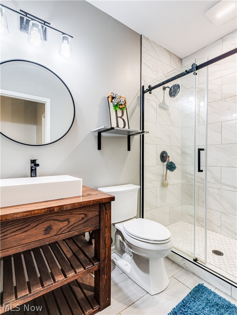 6573 Boneta Road Medina, OH 44256 - Photo 23 of 38 Bathroom with a shower with door, tile flooring, toilet, and vanity