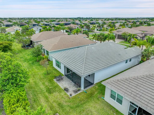 an aerial view of a house with a yard and lake view