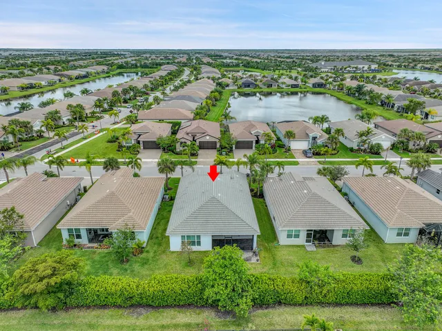 an aerial view of residential houses with outdoor space and street view