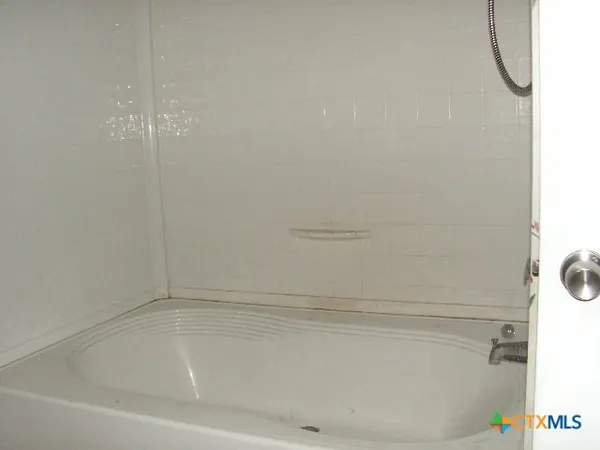 a bathroom with a glass shower door