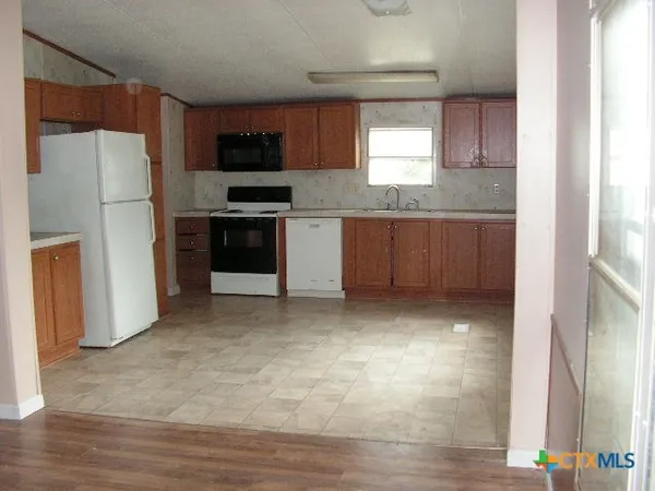 a kitchen with a refrigerator and a stove