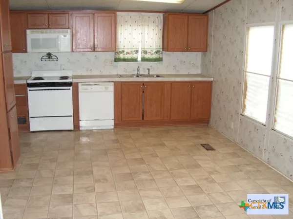 a kitchen with stainless steel appliances granite countertop a sink and cabinets