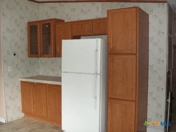 a white refrigerator freezer sitting in a kitchen