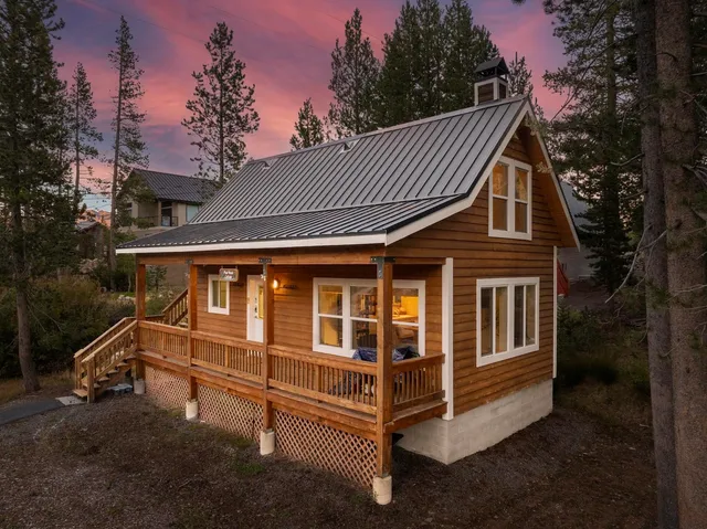 a view of a house with a yard and wooden fence