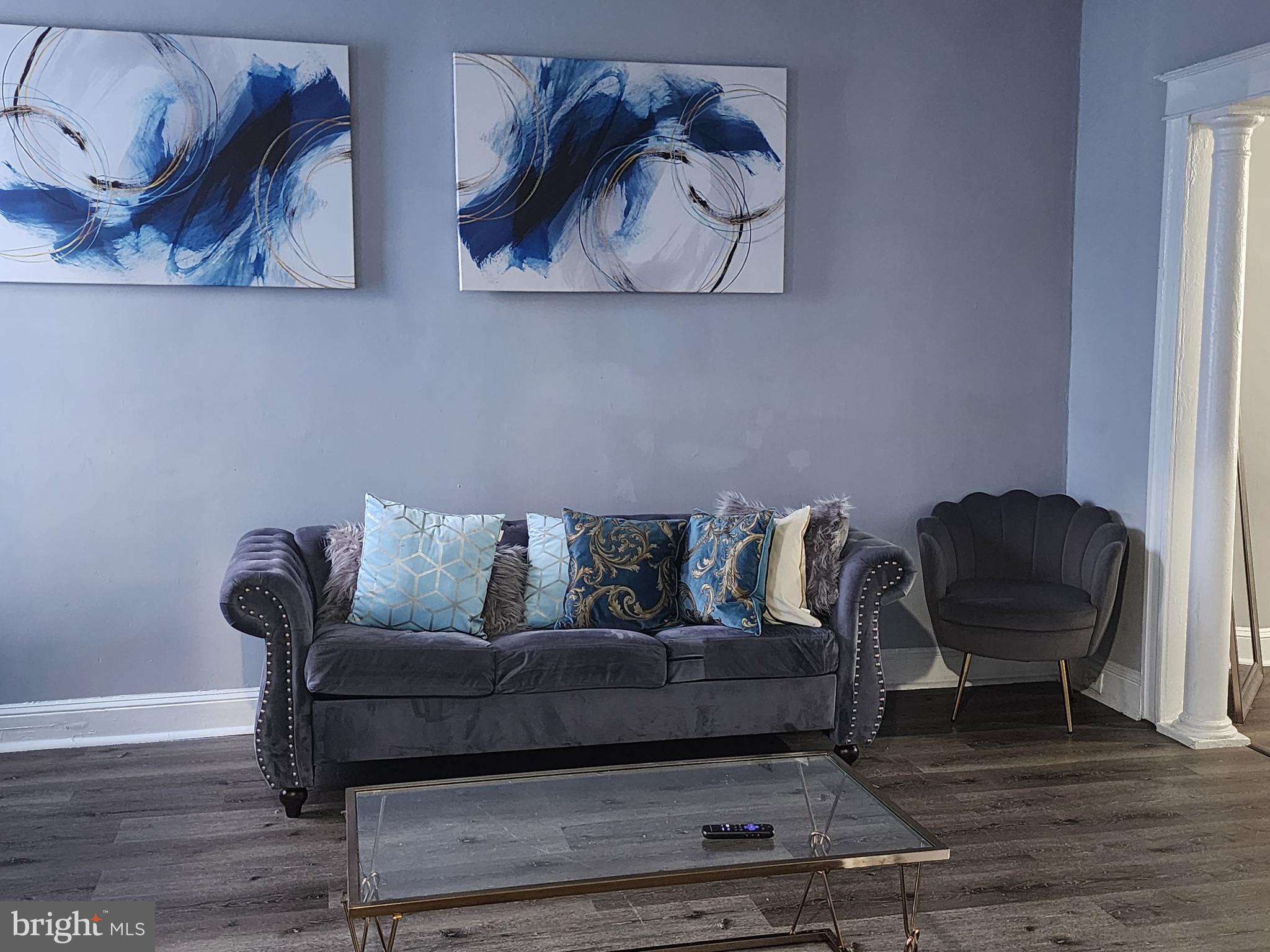 a living room with furniture and a piano