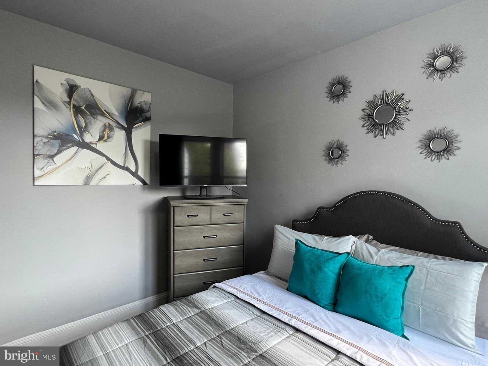 622 Allendale Street Baltimore, MD 21229 - Photo 15 of 29 a bedroom with a bed and a flat screen tv