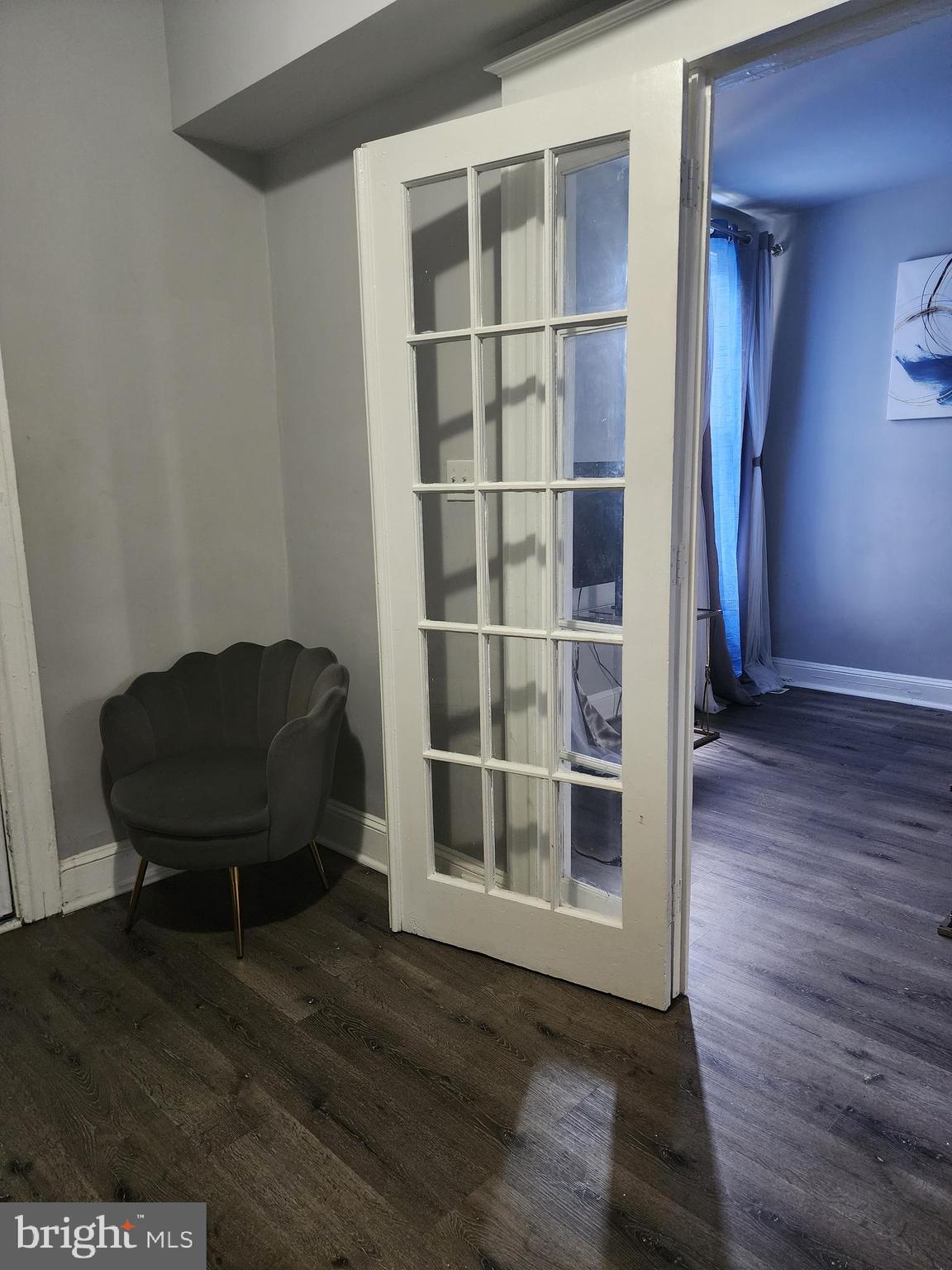 622 Allendale Street Baltimore, MD 21229 - Photo 26 of 29 a view of a livingroom with wooden floor and a bookshelf