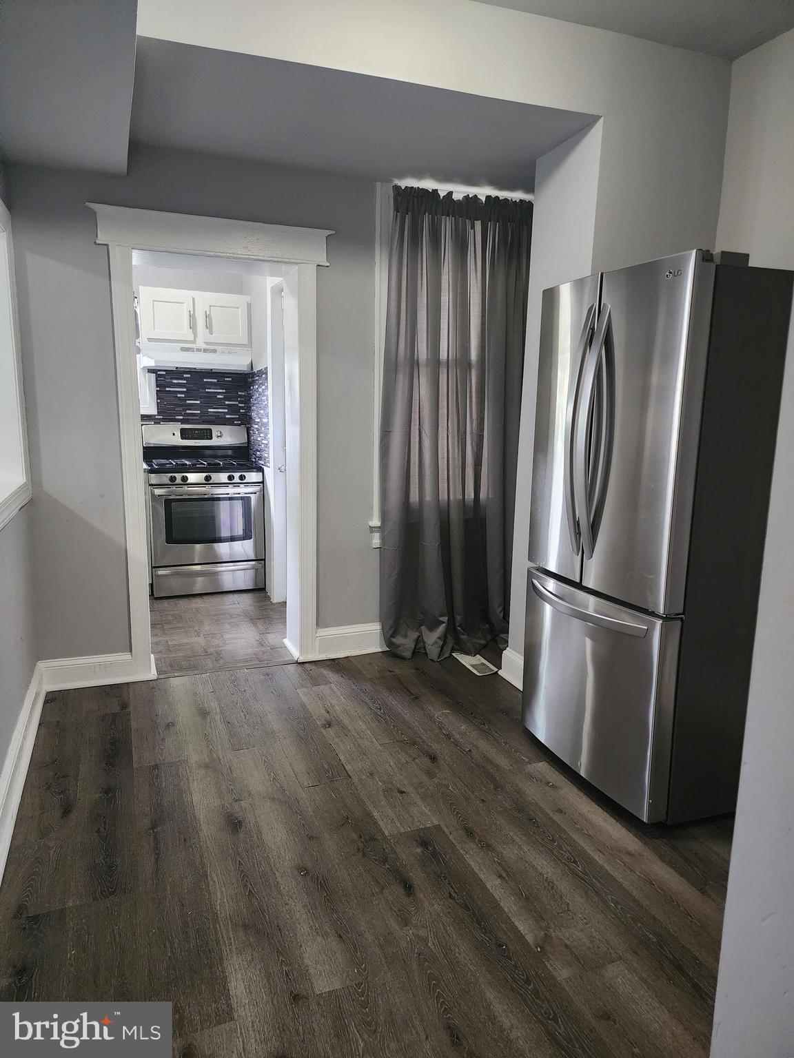 622 Allendale Street Baltimore, MD 21229 - Photo 7 of 29 a kitchen with a refrigerator and a stove
