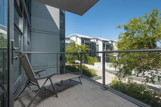 a view of a chair and table in the balcony