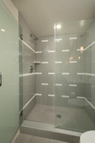 a bedroom with a bed and large window