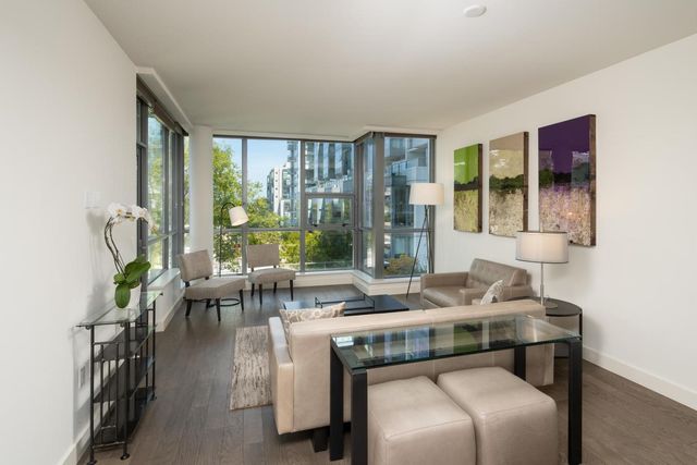 a living room with furniture and large windows