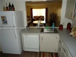 a kitchen with a sink and a refrigerator