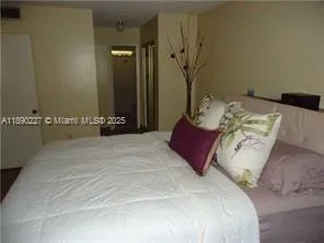 a bedroom with a bed and a night stand