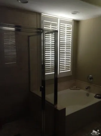 a bathroom with a bathtub and a shower