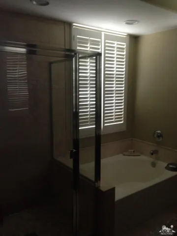 a bathroom with a bathtub and a shower