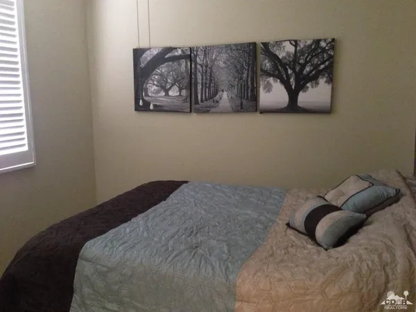 a bedroom with a bed and wall painting