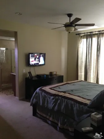 a bedroom with a bed and a chandelier