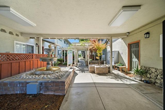a bedroom with furniture and large windows
