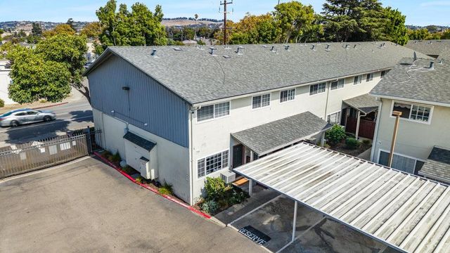 an aerial view of a house with roof deck front of house