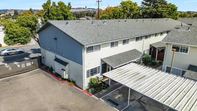an aerial view of a house with roof deck front of house