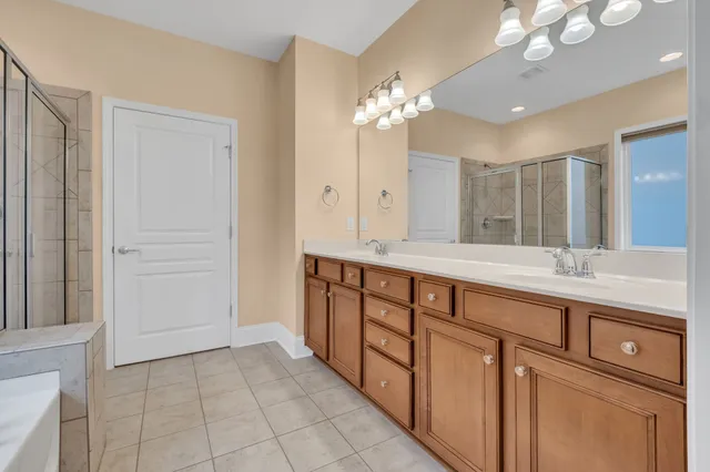 a bathroom with a double vanity sink and a mirror
