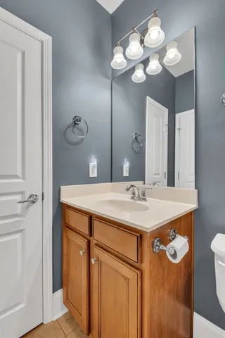 a bathroom with a sink a light fixture and a mirror