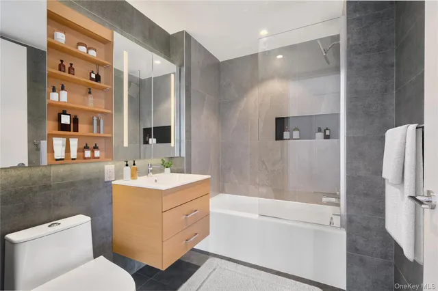 a bathroom with a sink toilet tub and shower