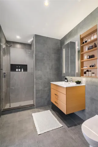 a bathroom with a double vanity sink mirror and shower